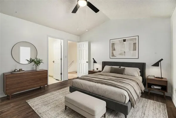 a bedroom with a bed a mirror and a table