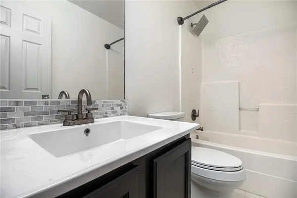 a bathroom with a sink a toilet and a bathtub