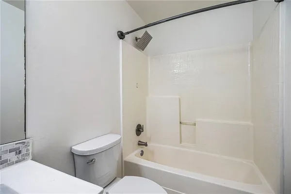 a bathroom with a toilet and a bathtub