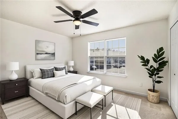 a bedroom with a large bed and a window