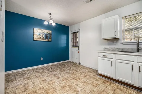 a kitchen with a stove a sink and a window