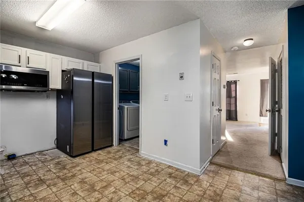 a view of a refrigerator in kitchen and living room