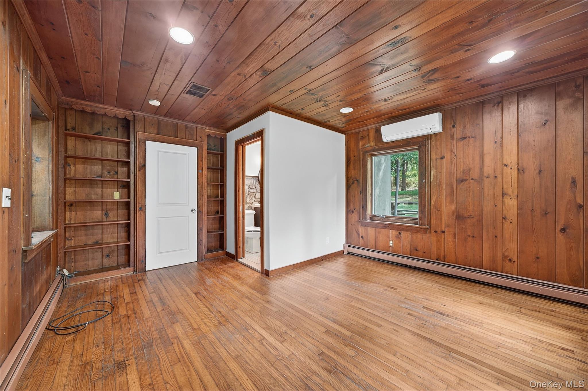 91 Sleepy Valley Road Warwick, NY 10990 - Photo 15 of 30 an empty room with wooden floor and windows