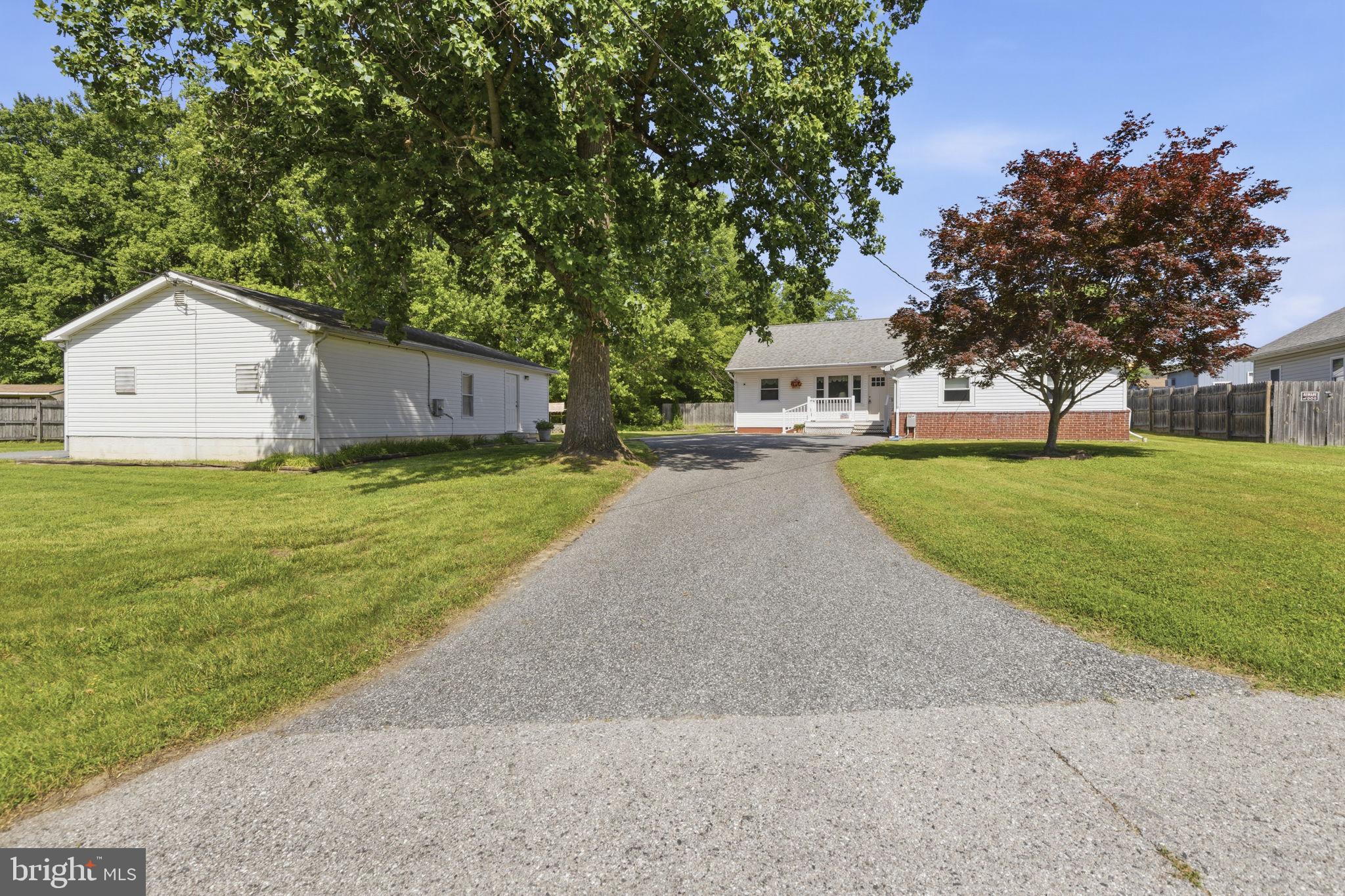 2411 Poplar Road Baltimore, MD 21221 - Photo 32 of 36 a white house with a big yard plants and large trees