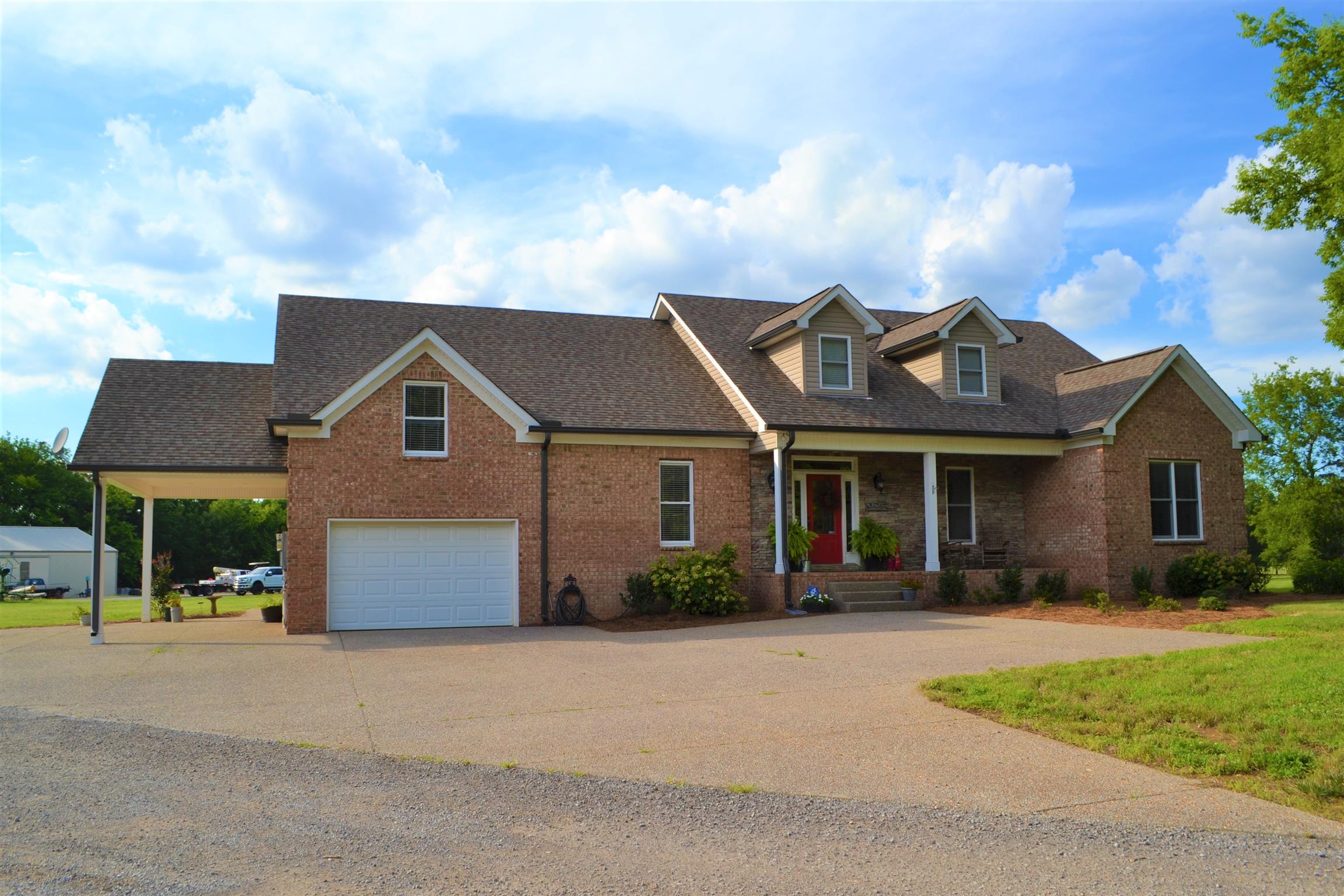 730 Walnut Grove Road Lebanon, TN 37090 - Photo 1 of 29 11 acres fenced w/ 60x72 heated/cooled shop w/elect & water; 47x72 Hay Barn w/ concrete floor & elect; 28x36 Barn; Approx 2809 SF Brick 3 Bedroom + office 3 Baths & Bonus Room; 18x49 Covered Porch with Outside Kit FP w/ gas logs sink w/ granite tops;