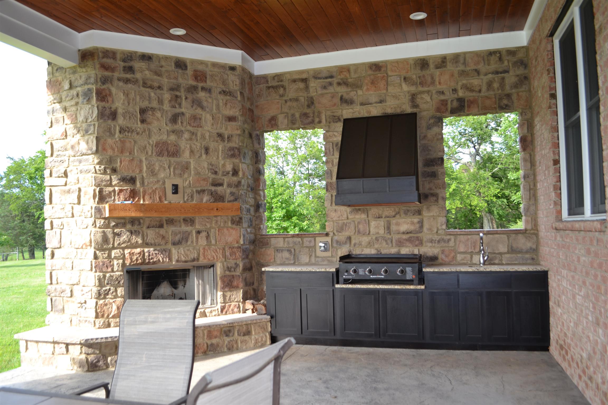730 Walnut Grove Road Lebanon, TN 37090 - Photo 17 of 29 18X49 COVERED BACKPORCH HAS CUSTOM CABINETS WITH GRILL AND GAS FIREPLACE IN THE CUSTOM OUTSIDE LIVING COVERED WOOD CEILING BACK PORCH WITH SINK & GRANITE TOPS OVERLOOKING THE 11 ACRES; LOTS OF AREA FOR PLAY OR FOR GARDEN AREA