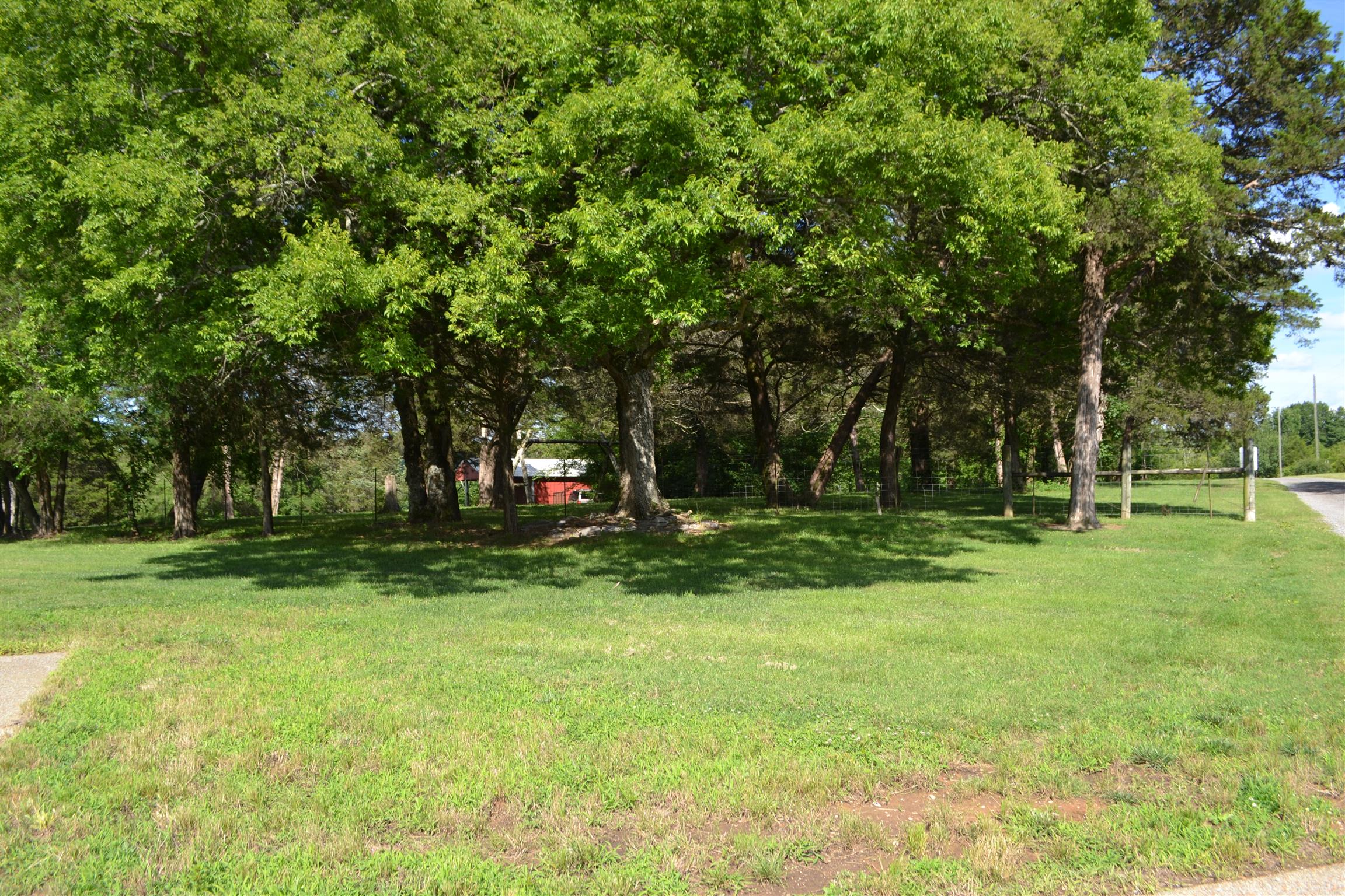 730 Walnut Grove Road Lebanon, TN 37090 - Photo 2 of 29 NO RESTRICTIONS & NO HOA ON THIS FENCED 11 ACRE PROPERTY WITH APPROX 2809 SF BRICK HOME WIRED TO RUN OFF A GENERATOR; SHOP, HAY BARN, SHEDS, GOAT/COW BARN; 2 CAR GARAGE WITH CARPORT