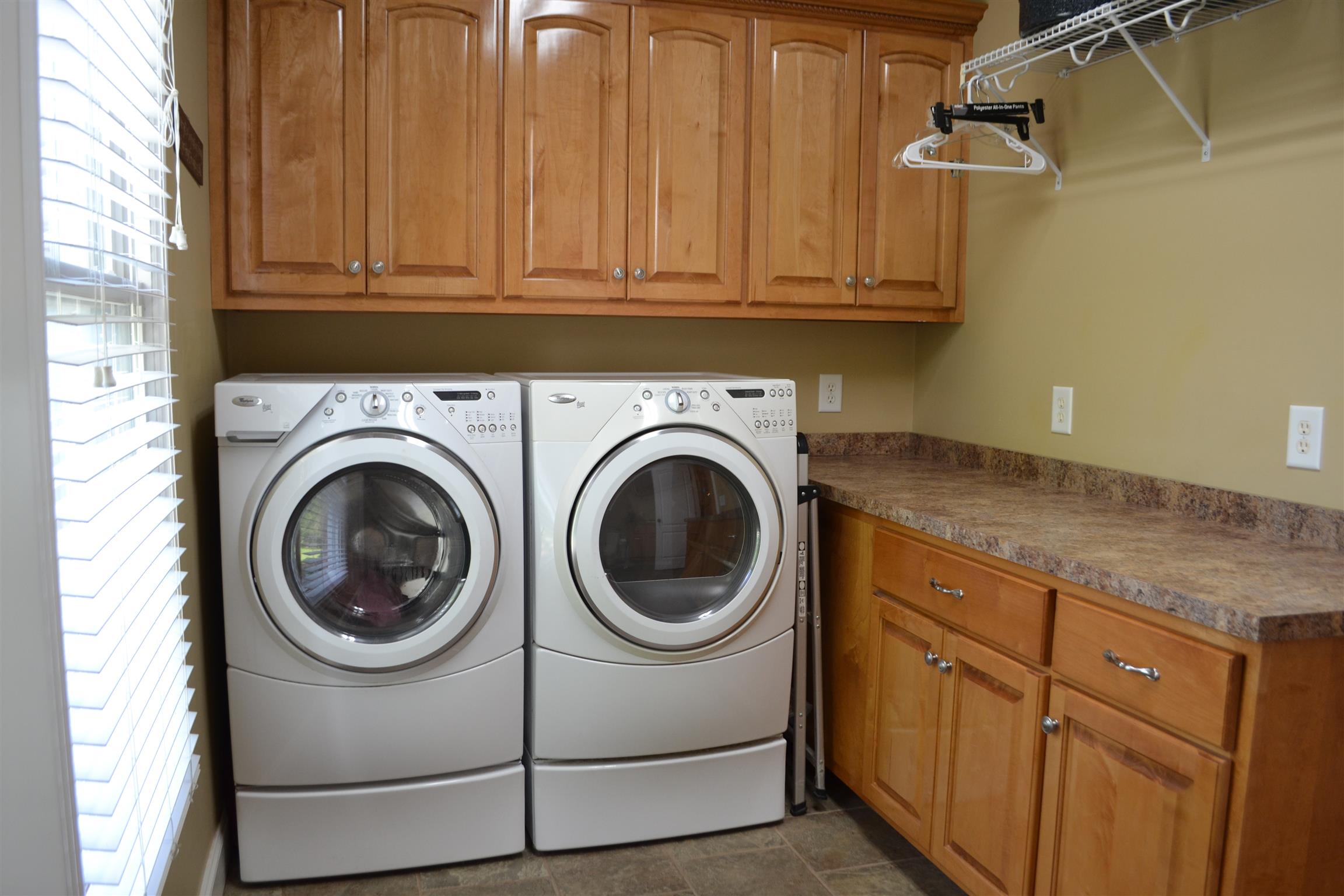 730 Walnut Grove Road Lebanon, TN 37090 - Photo 22 of 29 HOME HAS LAUNDRY ROOM WITH BUILT IN CUSTOM CABINETS FOR FOLDING CLOTHES AND HAS TILE FLOOR; LAUNDRY ROOM HAS 1/2 BATH
