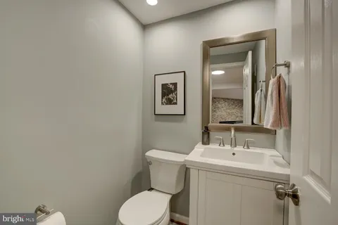 a bathroom with a toilet sink and mirror