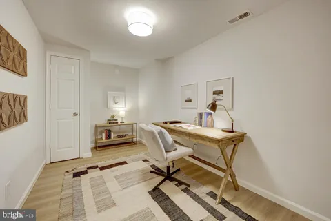 a view of a workspace with furniture and a table