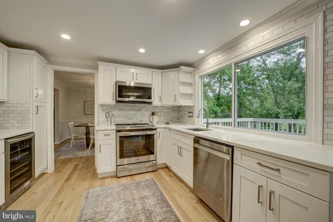 a kitchen with a sink a window and stainless steel appliances
