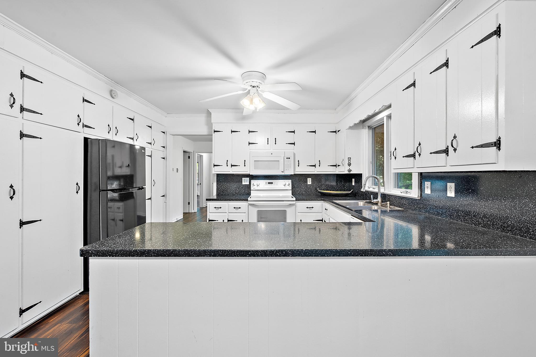 6181 Rockawalkin Road Salisbury, MD 21801 - Photo 17 of 65 a large kitchen with granite countertop a lot of counter space stainless steel appliances and cabinets