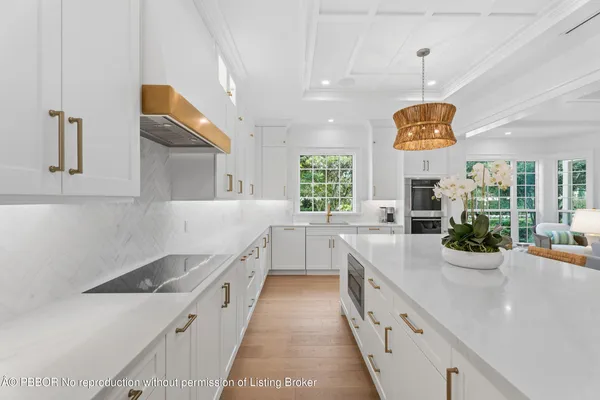 a large white kitchen with a large window