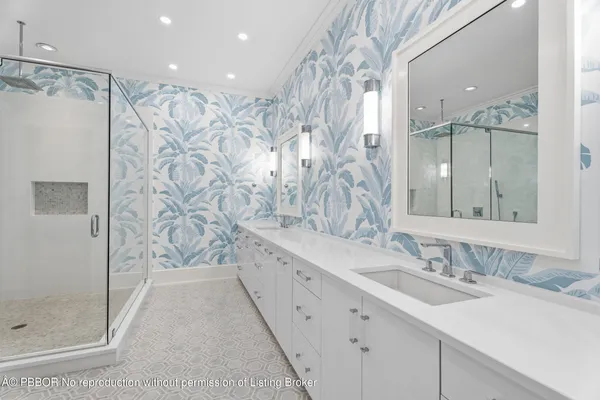 a bathroom with a double vanity sink mirror and shower