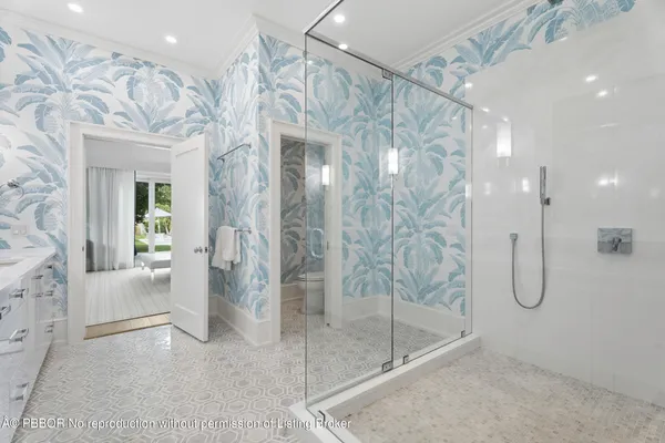 a bathroom with a glass shower door and a sink