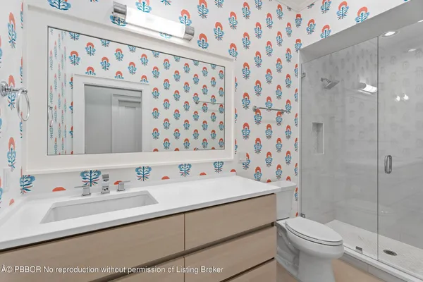 a bathroom with a sink toilet and shower