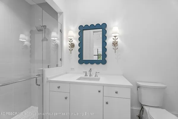 a bathroom with a sink vanity and toilet
