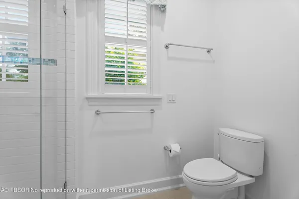 a white toilet sitting next to a window