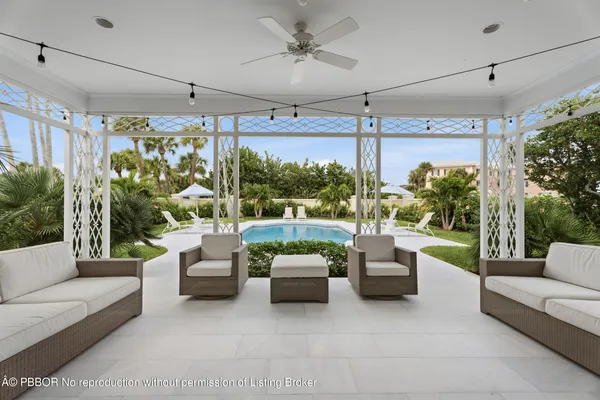 a outdoor living space with patio furniture and a chandelier