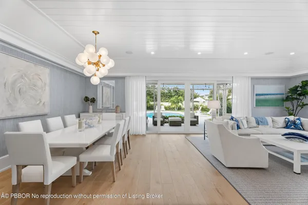 a living room with furniture chandelier and a table