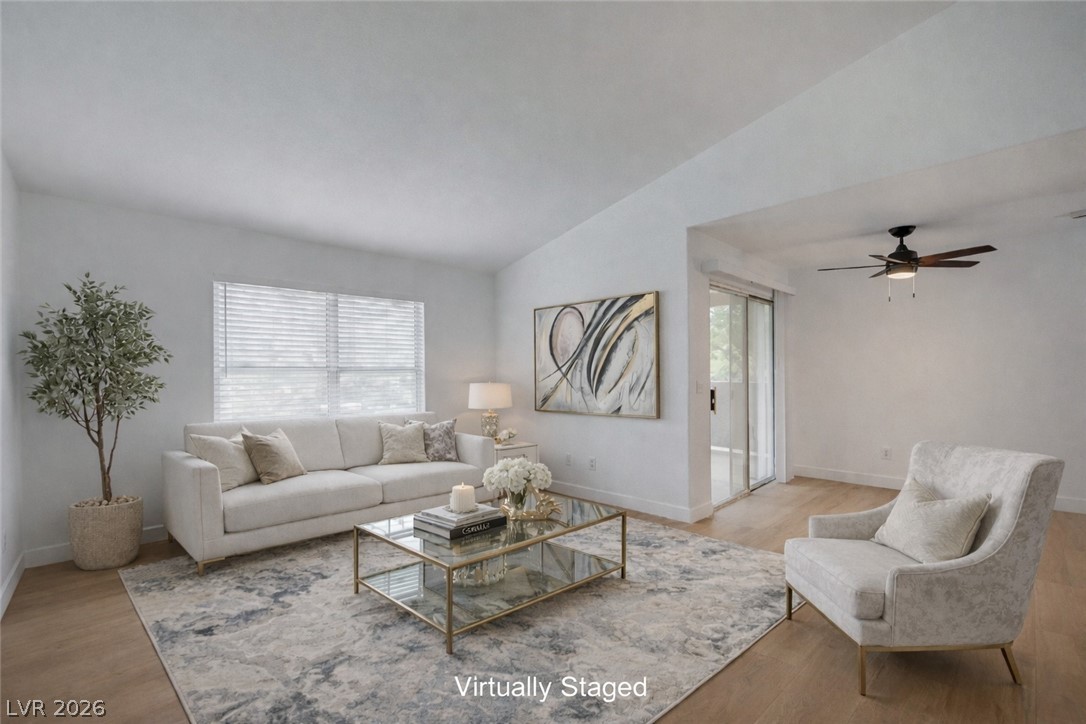 Virtually Stage Living area with lofted ceiling, wood finished floors, and ceiling fan