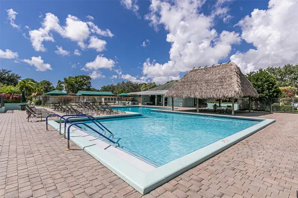 a view of a swimming pool with an outdoor seating
