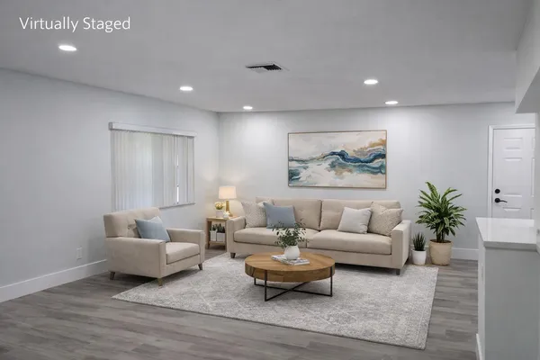 a living room with furniture and wooden floor