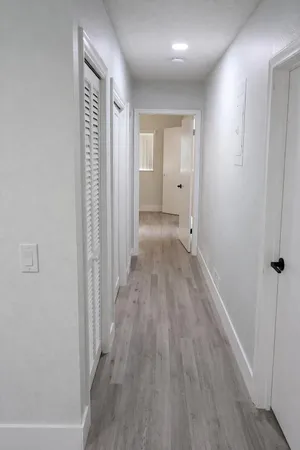 a view of a hallway with wooden floor