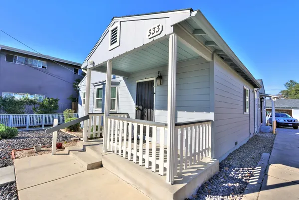 a view of a house with a wooden deck