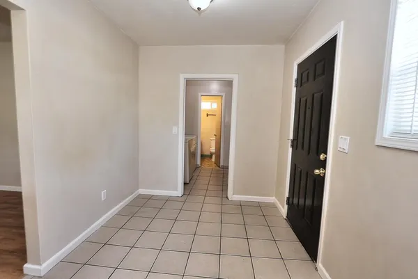 a bathroom with a granite countertop toilet sink and mirror