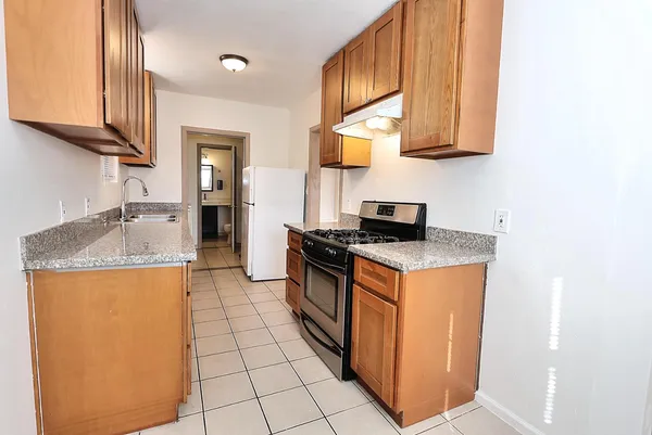 a kitchen with stainless steel appliances granite countertop a stove and a refrigerator