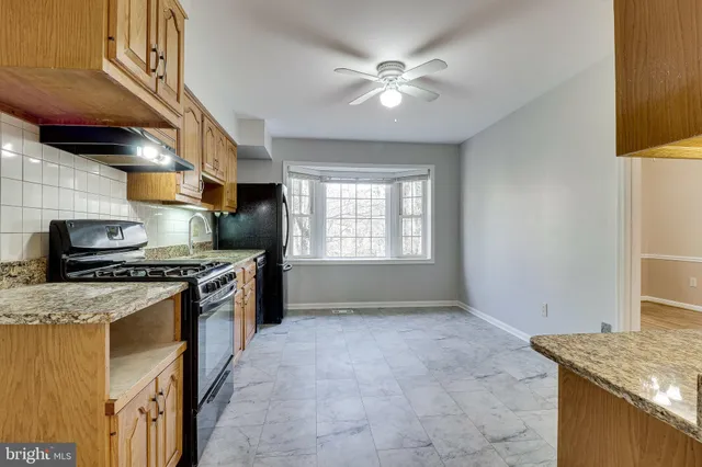 a view of a kitchen with a refrigerator and windows