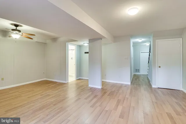 a front view of a house with a large tree