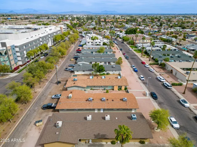 an aerial view of residential houses with outdoor space