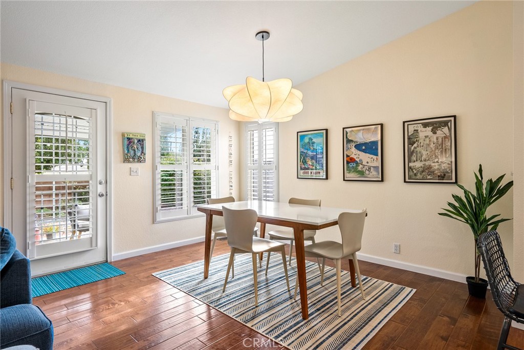 378 Lark Drive Paso Robles, CA 93446 - Photo 7 of 33 a dining room with wooden floor a chandelier a glass table and chairs