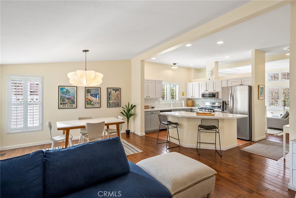 378 Lark Drive Paso Robles, CA 93446 - Photo 8 of 33 a living room with furniture a dining table wooden floor and a fireplace