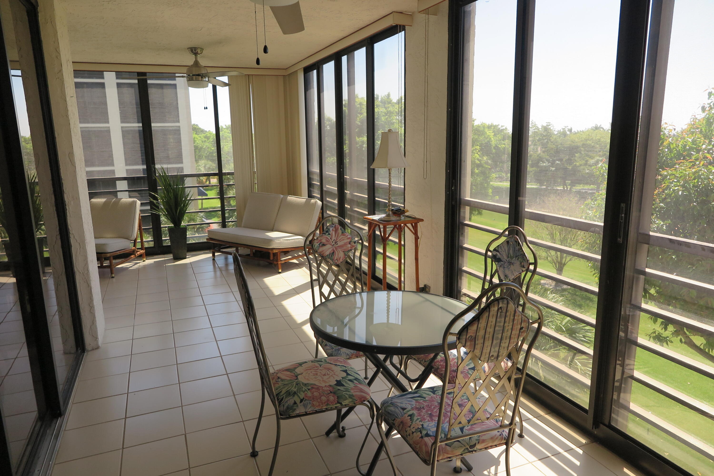 7578 Regency Lake Drive, Unit 501 Boca Raton, FL 33433 - Photo 11 of 32 a dining room with furniture water view and a floor to ceiling window