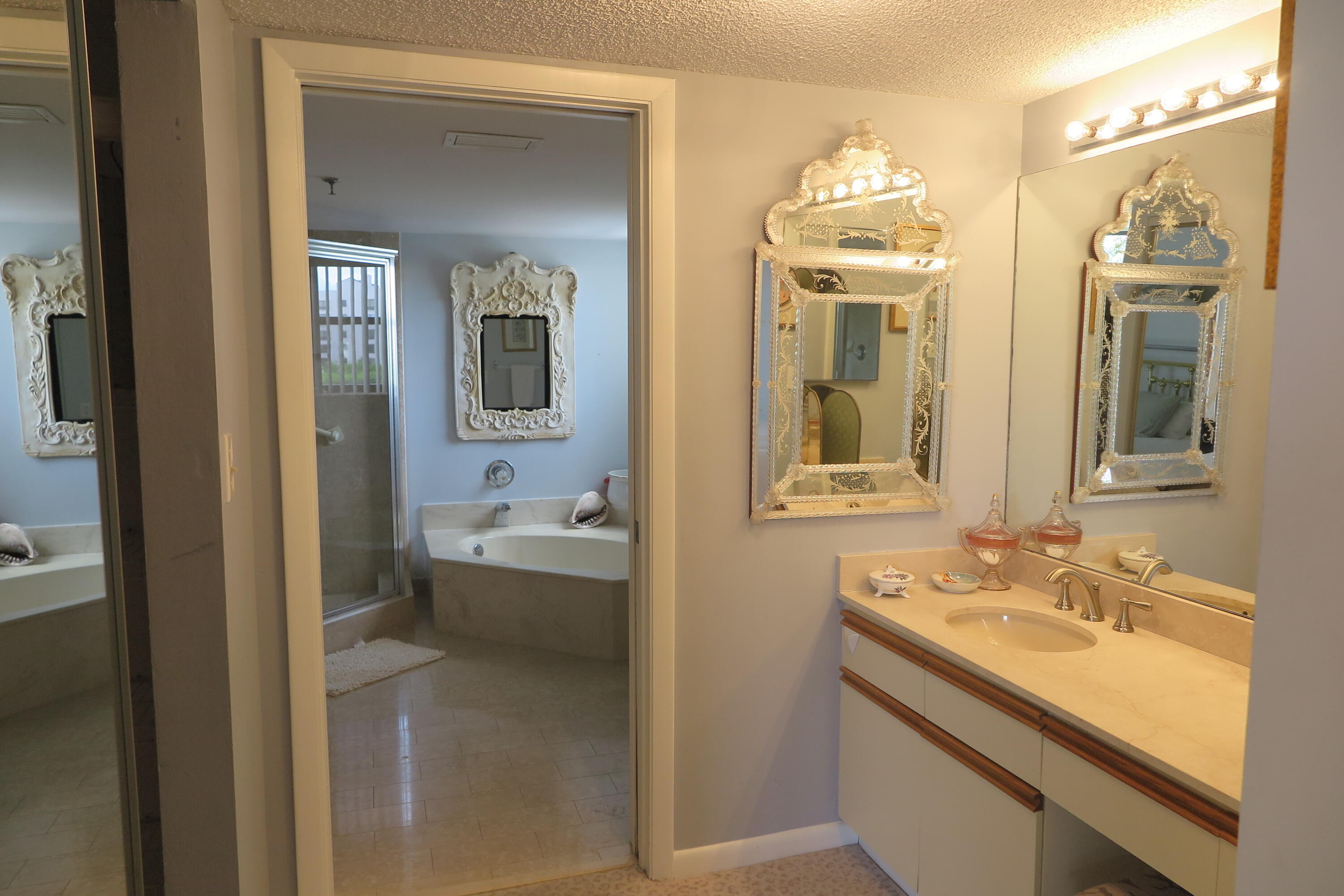 7578 Regency Lake Drive, Unit 501 Boca Raton, FL 33433 - Photo 15 of 32 a bathroom with a sink and a mirror