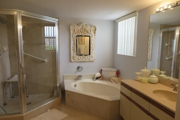 a bathroom with a sink mirror and a bathtub