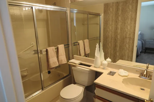 a bathroom with a sink toilet and shower