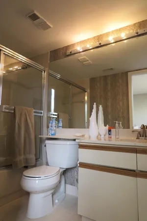 a bathroom with a toilet a sink and a mirror