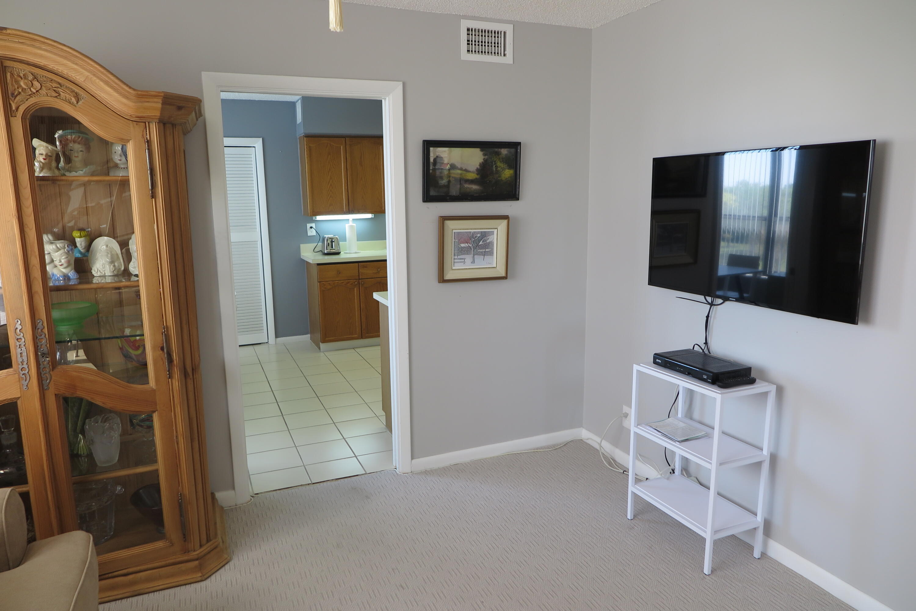 7578 Regency Lake Drive, Unit 501 Boca Raton, FL 33433 - Photo 25 of 32 a view of a livingroom with a flat screen tv