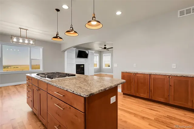a kitchen with a table chairs stainless steel appliances and cabinets