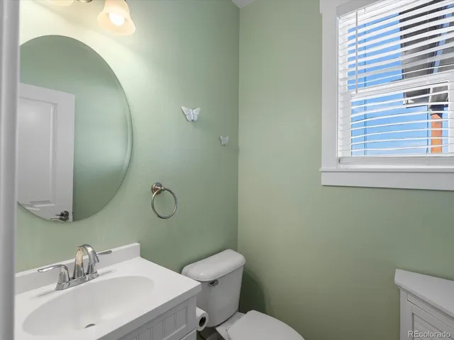 a view of a hallway with bathroom and mirror