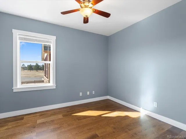 a bedroom with a bed a chandelier and window