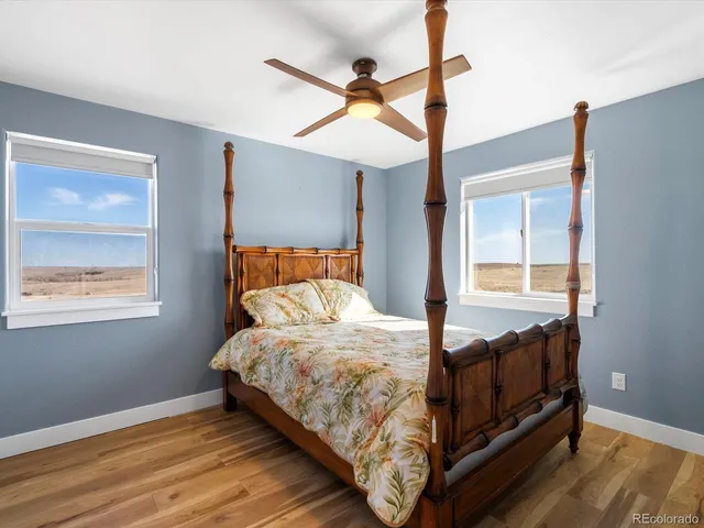 a view of a livingroom with a ceiling fan and window