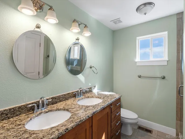 a view of empty room with wooden floor and fireplace