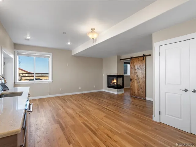 a view of an empty room with wooden floor