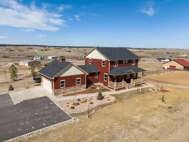 an aerial view of a house with a big yard
