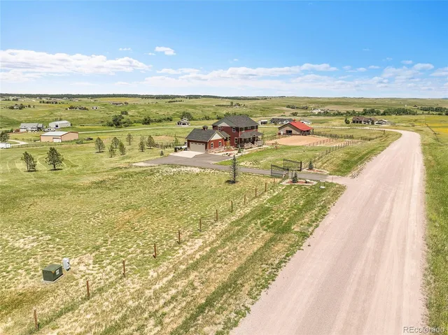 a kitchen with stainless steel appliances granite countertop a sink a stove and a wooden floors